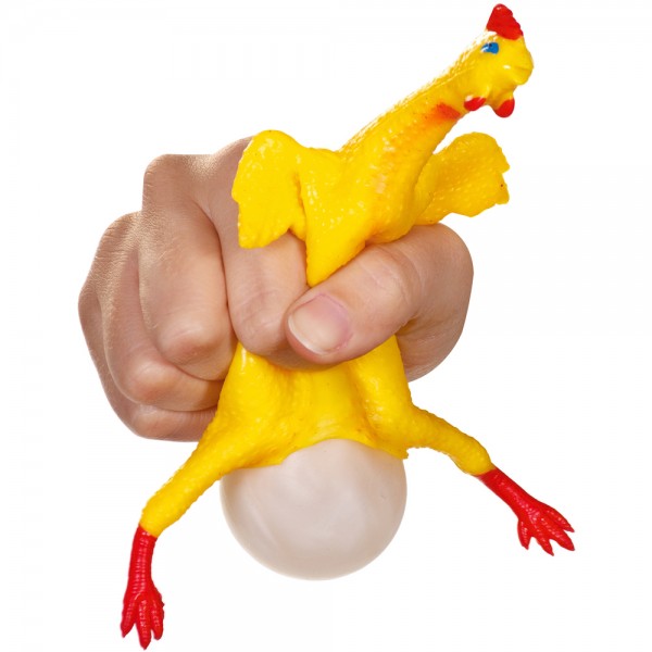 Egg laying rubber chicken that lays an egg when it is squeezed