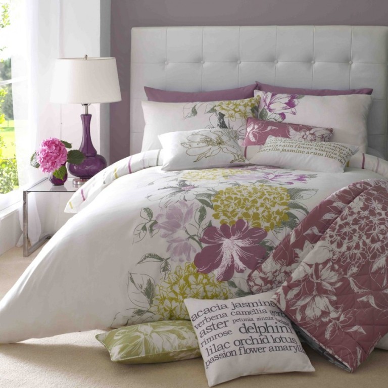 Fascinating-Floral-Print-Duvet-Cover-Set-on-Lavish-White-Bed-Small-Glass-Bedside-Table-with-Purple-Table-Lamp-Tufted-Bed-Headboard-906x906