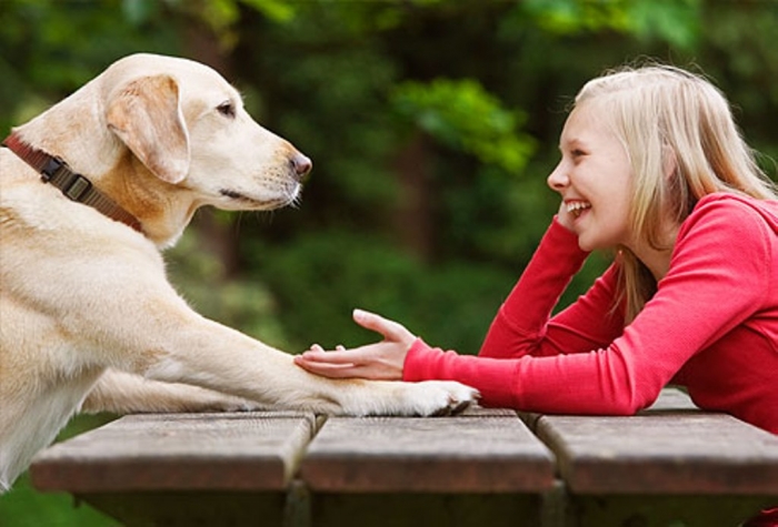 getty_rf_photo_of_girl_relaxing_while_talking_to_dog