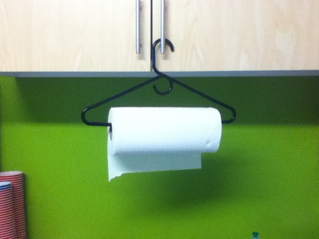 If you do not have a paper towel holder, then you can easily create a new one through using a hanger