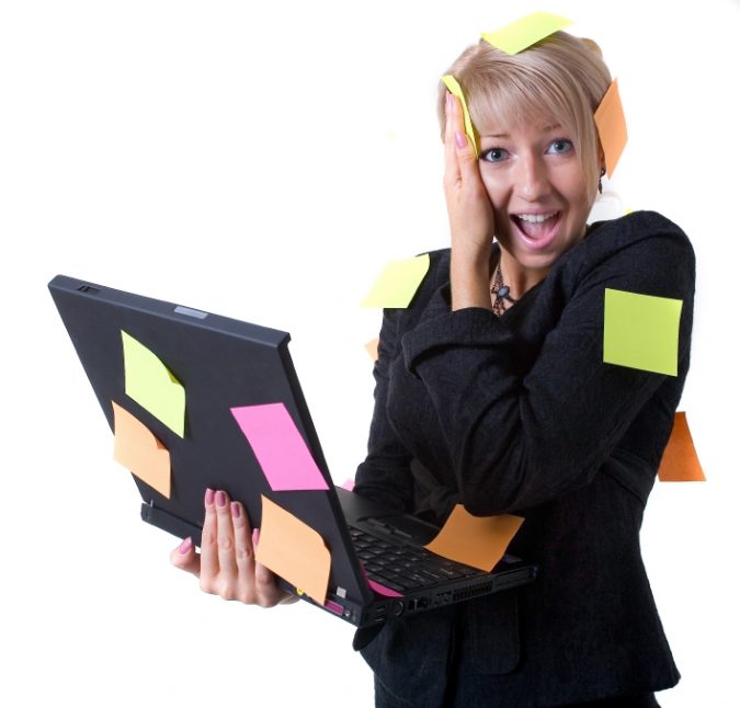 Businesswoman with notebook and reminding notes